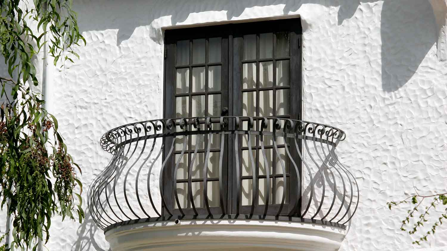 Balcony on a house with English stucco finish