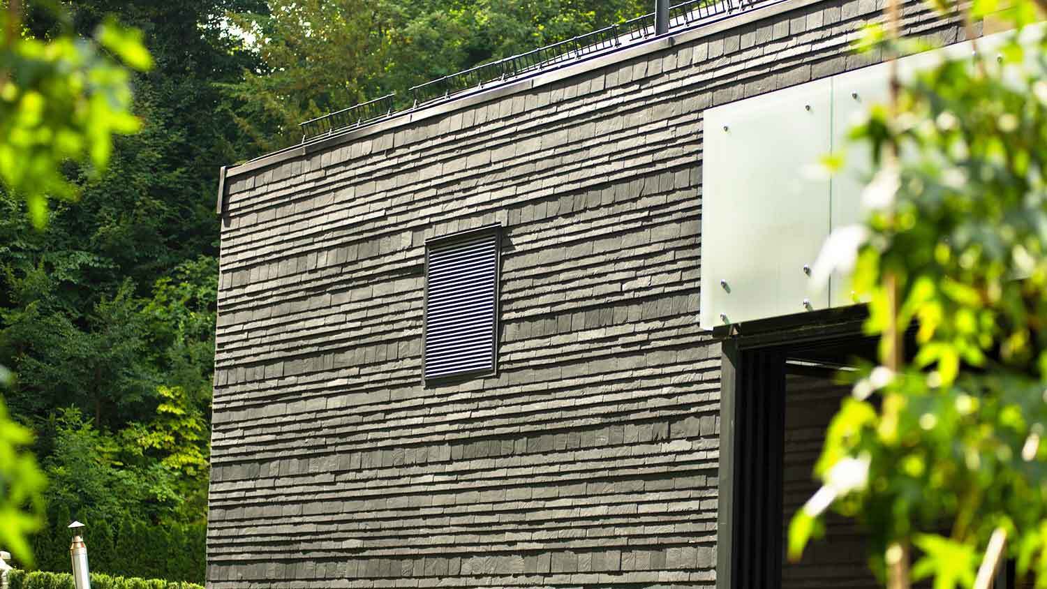 Contemporary house with black stone cladding