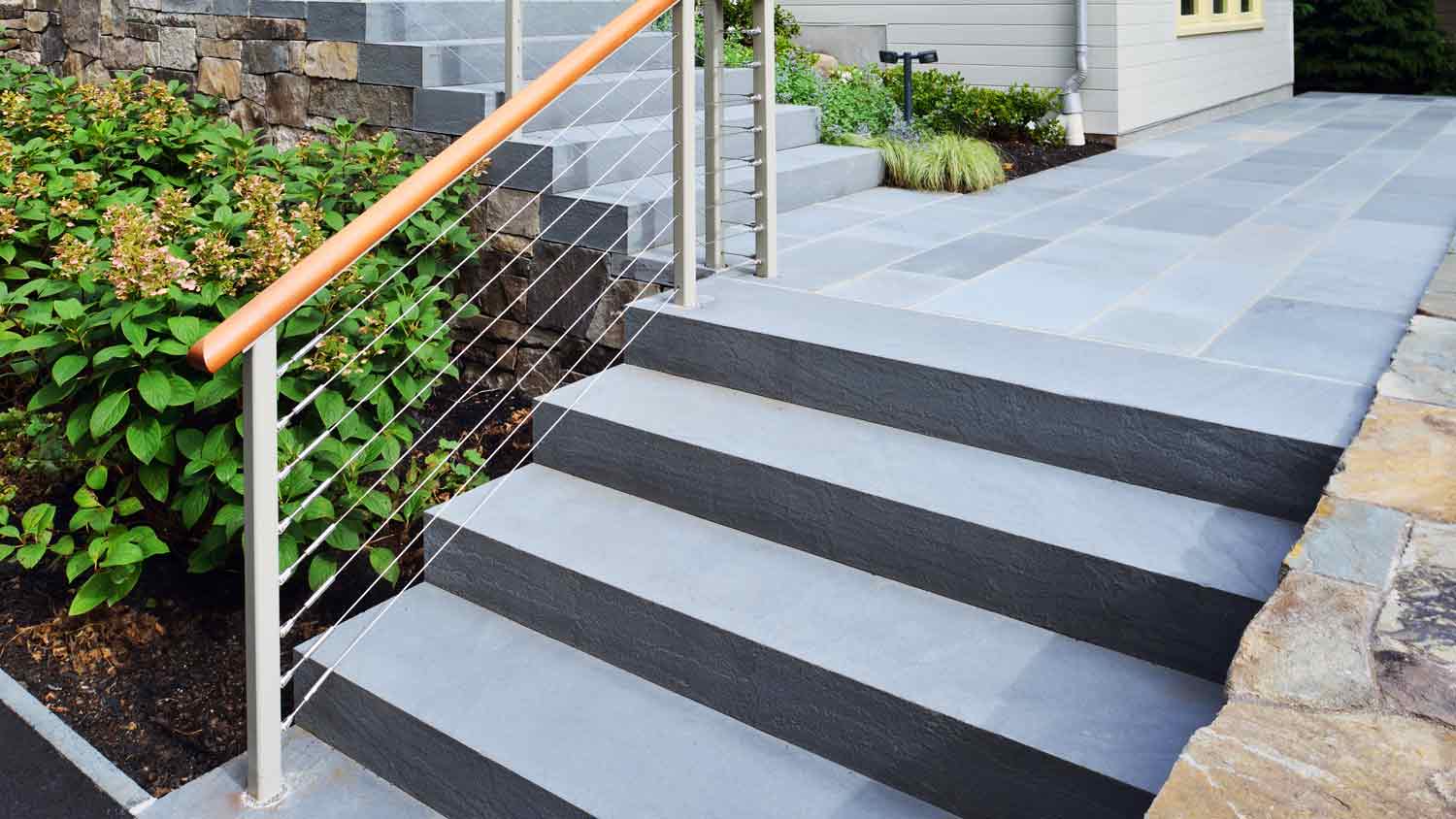 stone steps with flowers around in landscaping