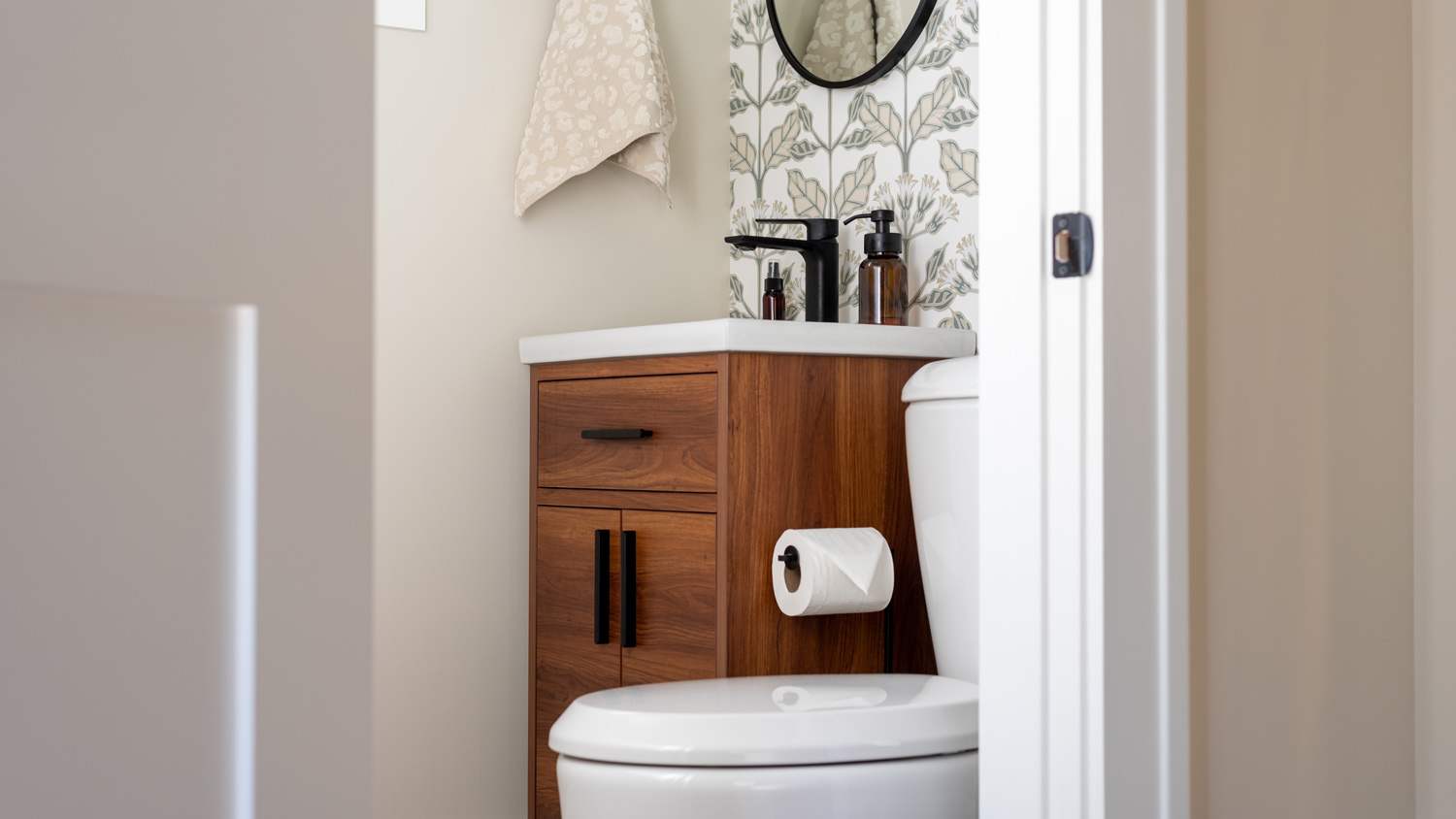 Stylish small bathroom with wallpaper accent wall