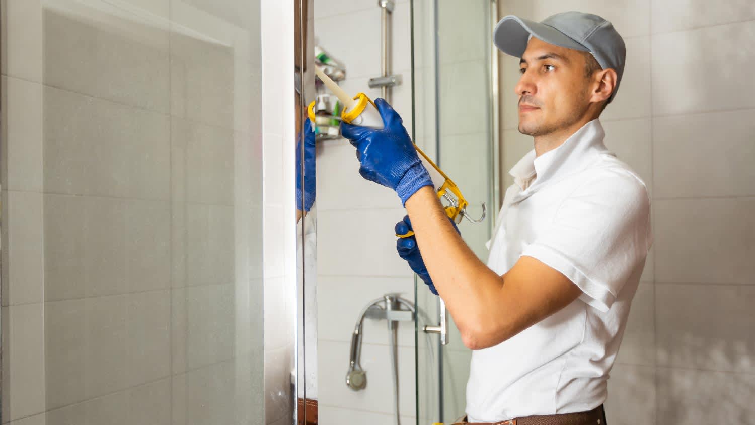 A man installing a shower cabin