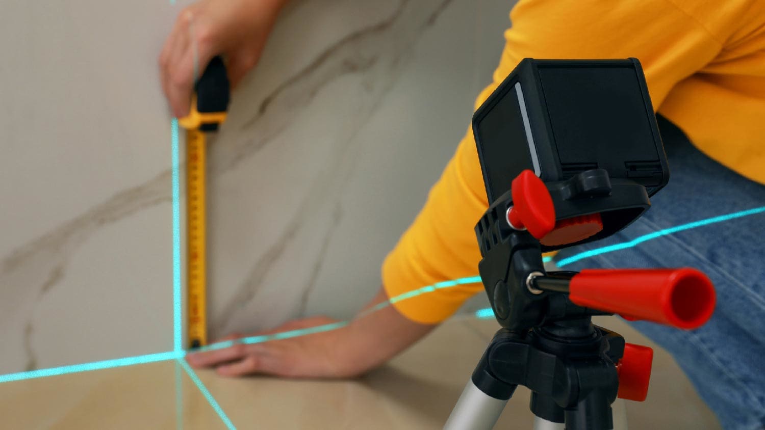 A person measuring a space for shower installation