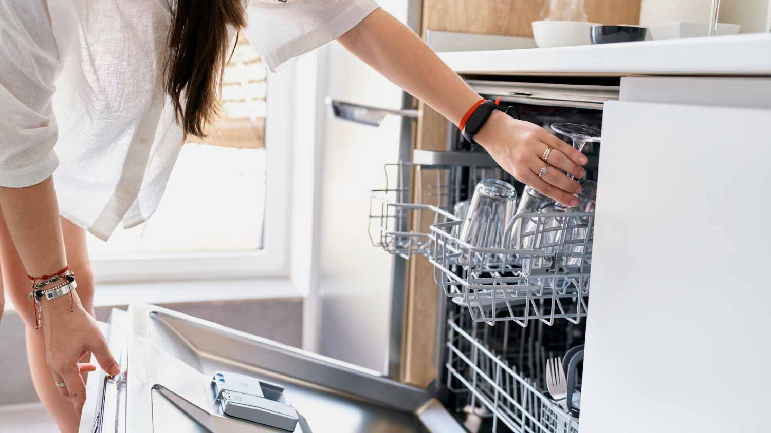 Woman loading dishwasher