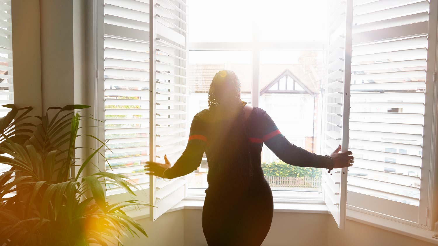 A woman opening shutters