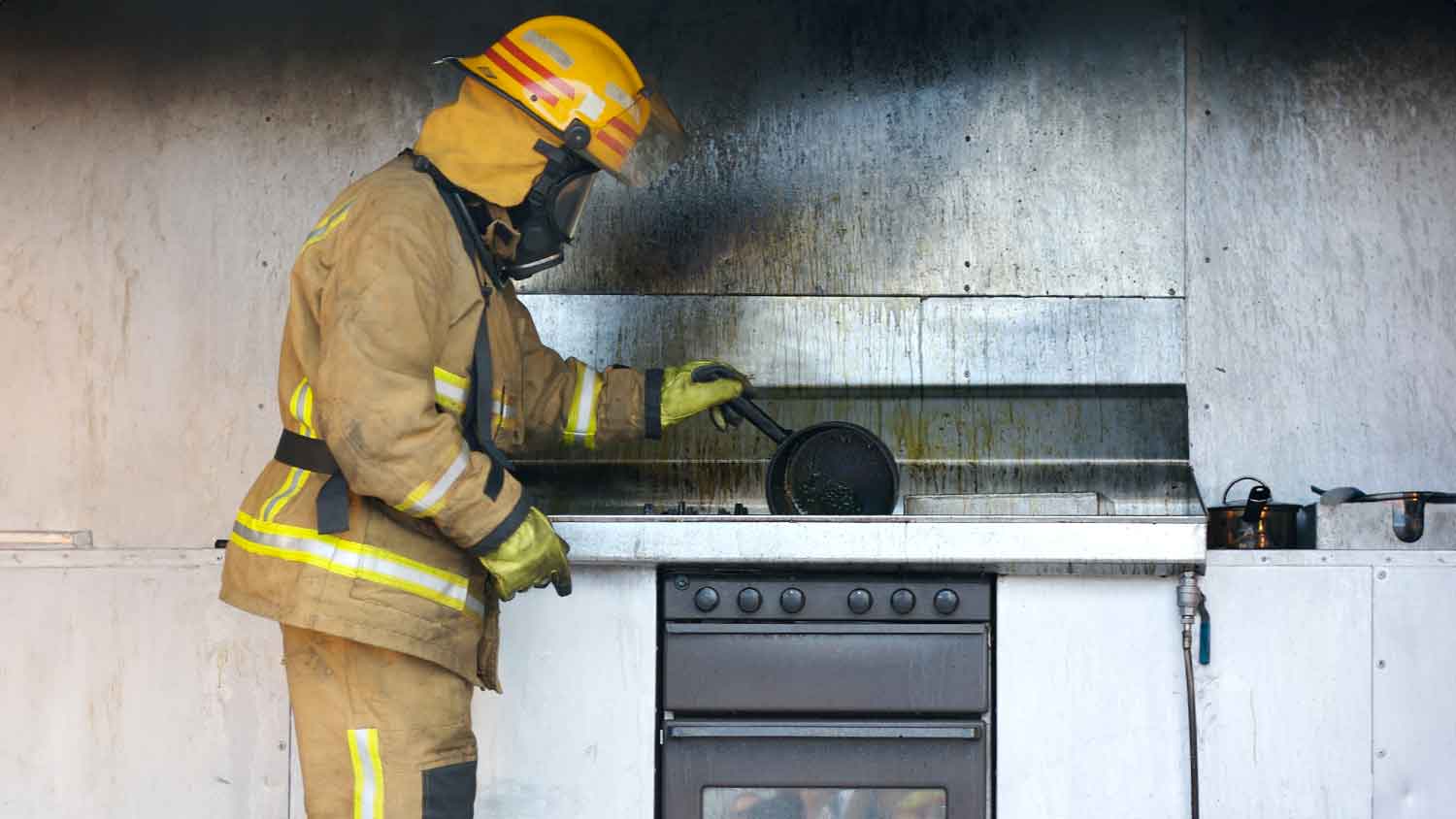 Firefighter-inspecting-burnt-kitchen