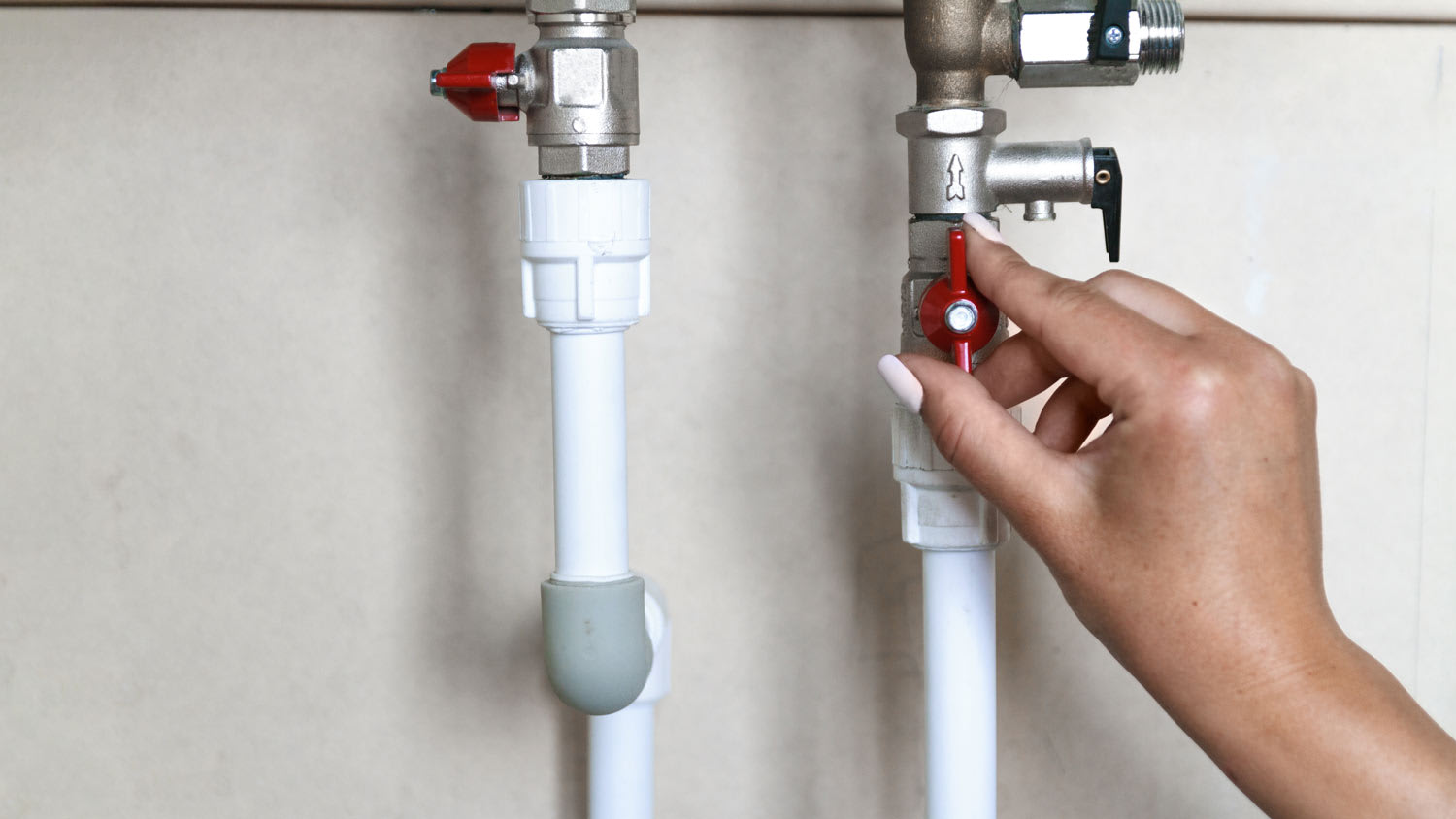 woman’s hand turning gas valve