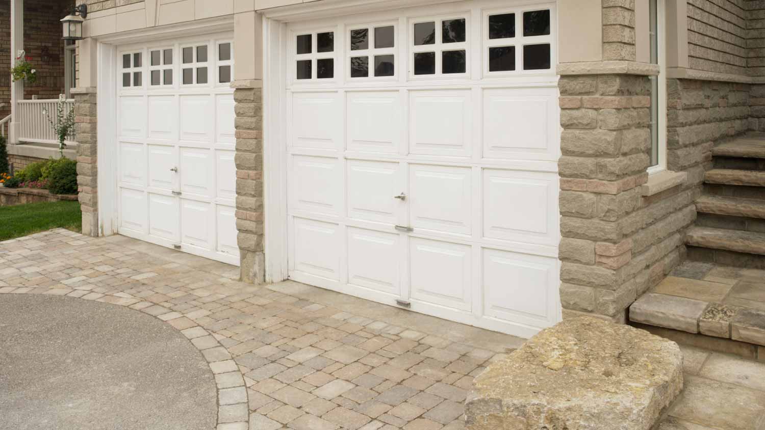 Double garage in the front of the stone house