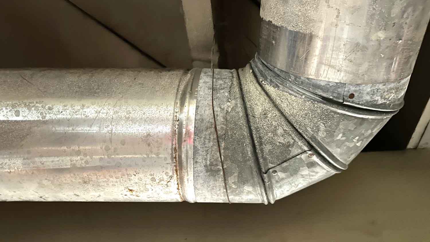 HVAC elbow joining duct pipes around the corner