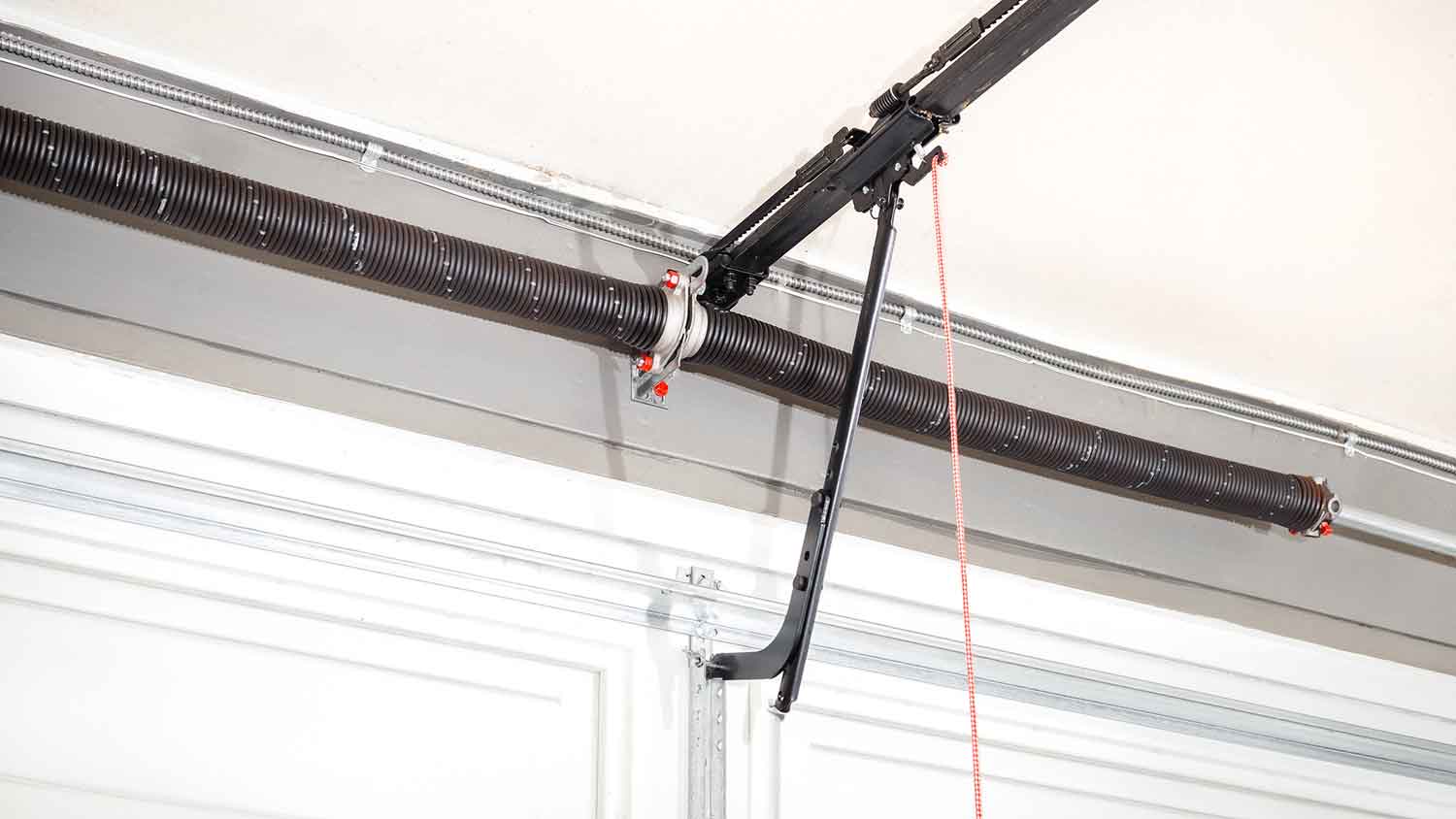 Torsion springs installed above automatic garage door