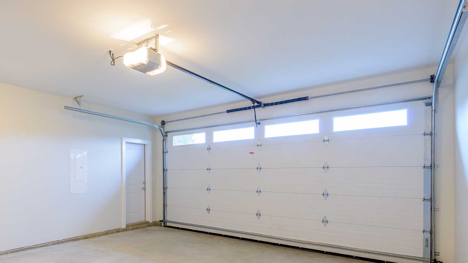 Empty garage interior with automatic garage door