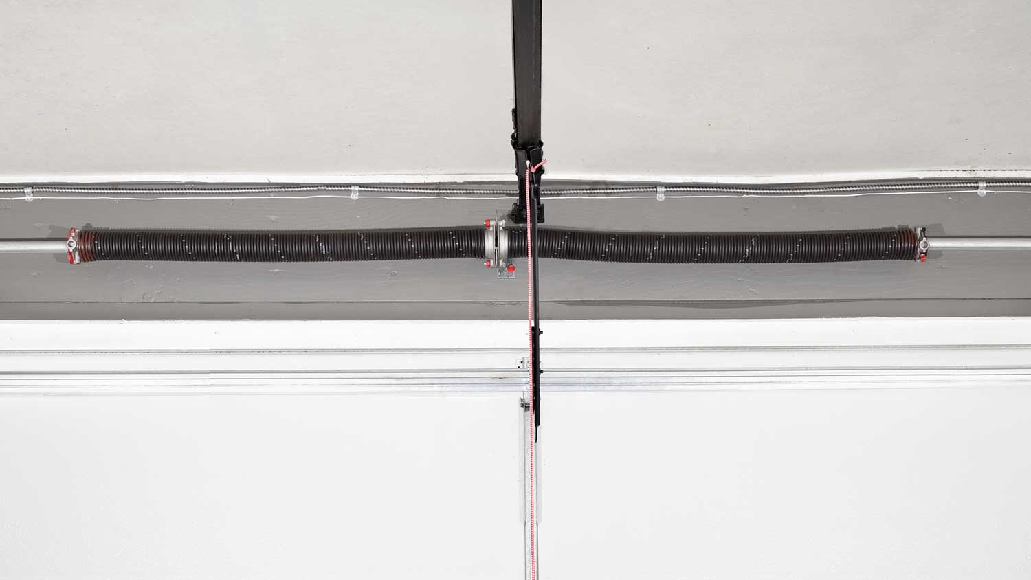 Electric garage door opener mounted on the ceiling