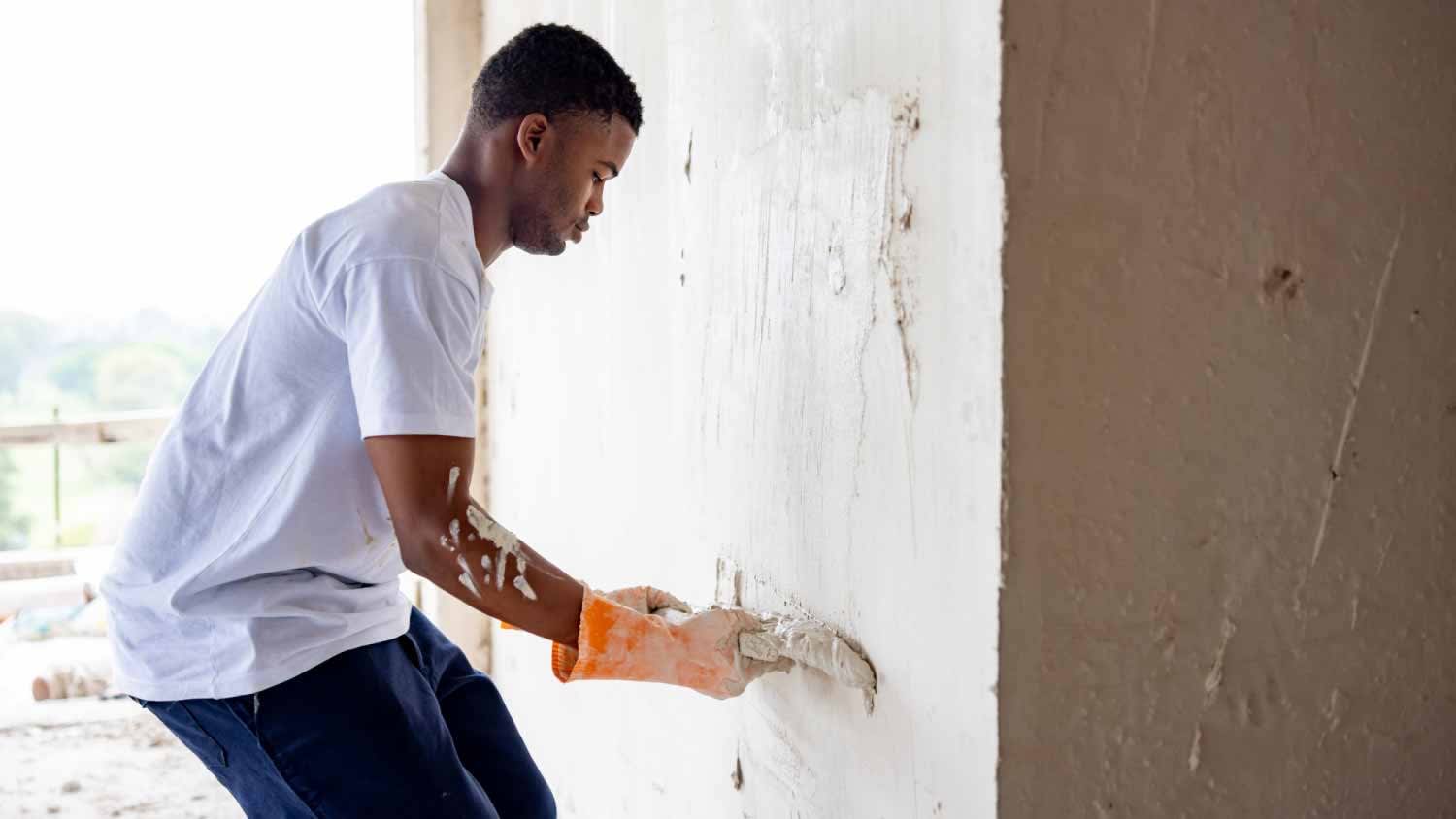 Construction worker plastering a wall