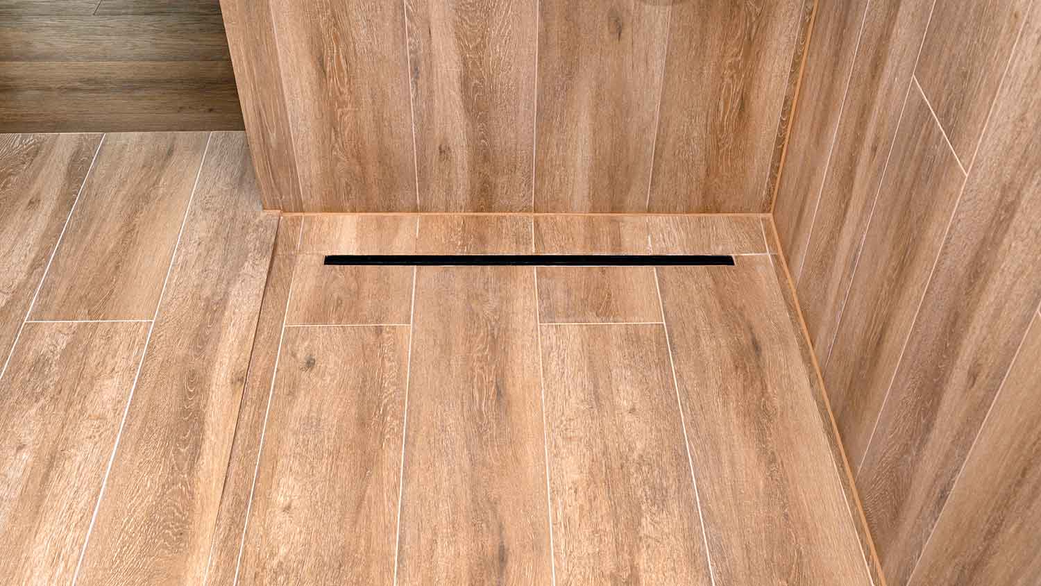 Linear drain installed along the edge of the shower