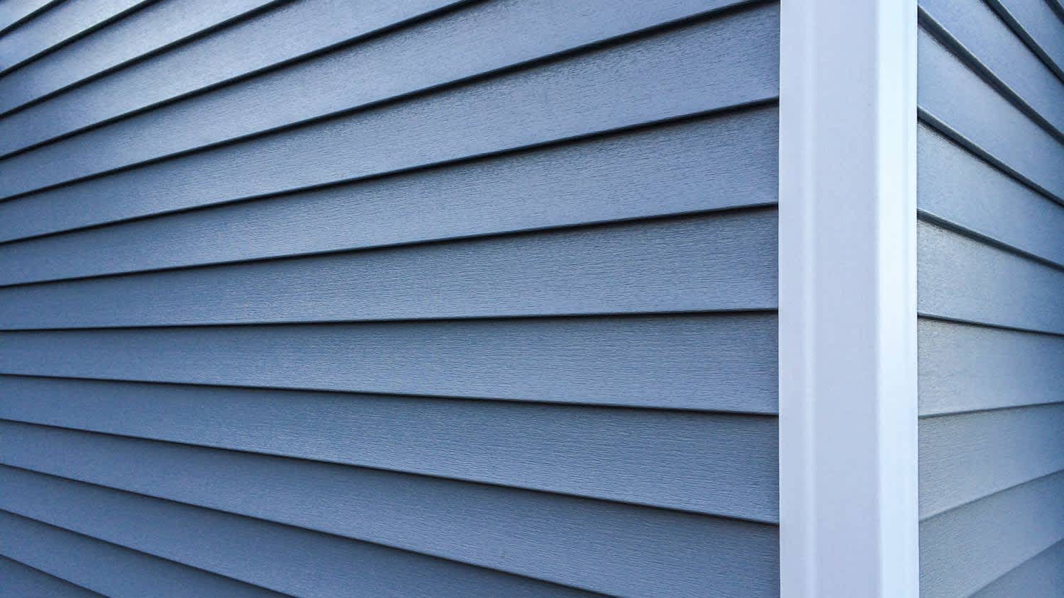 Detail of corner of house with blue siding
