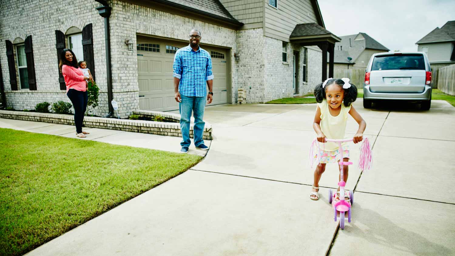 Family on concrete driveway
