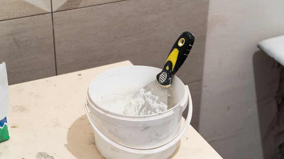 bucket of putty for tile joints