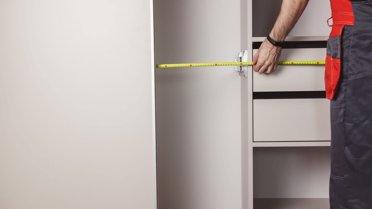 man measuring closet