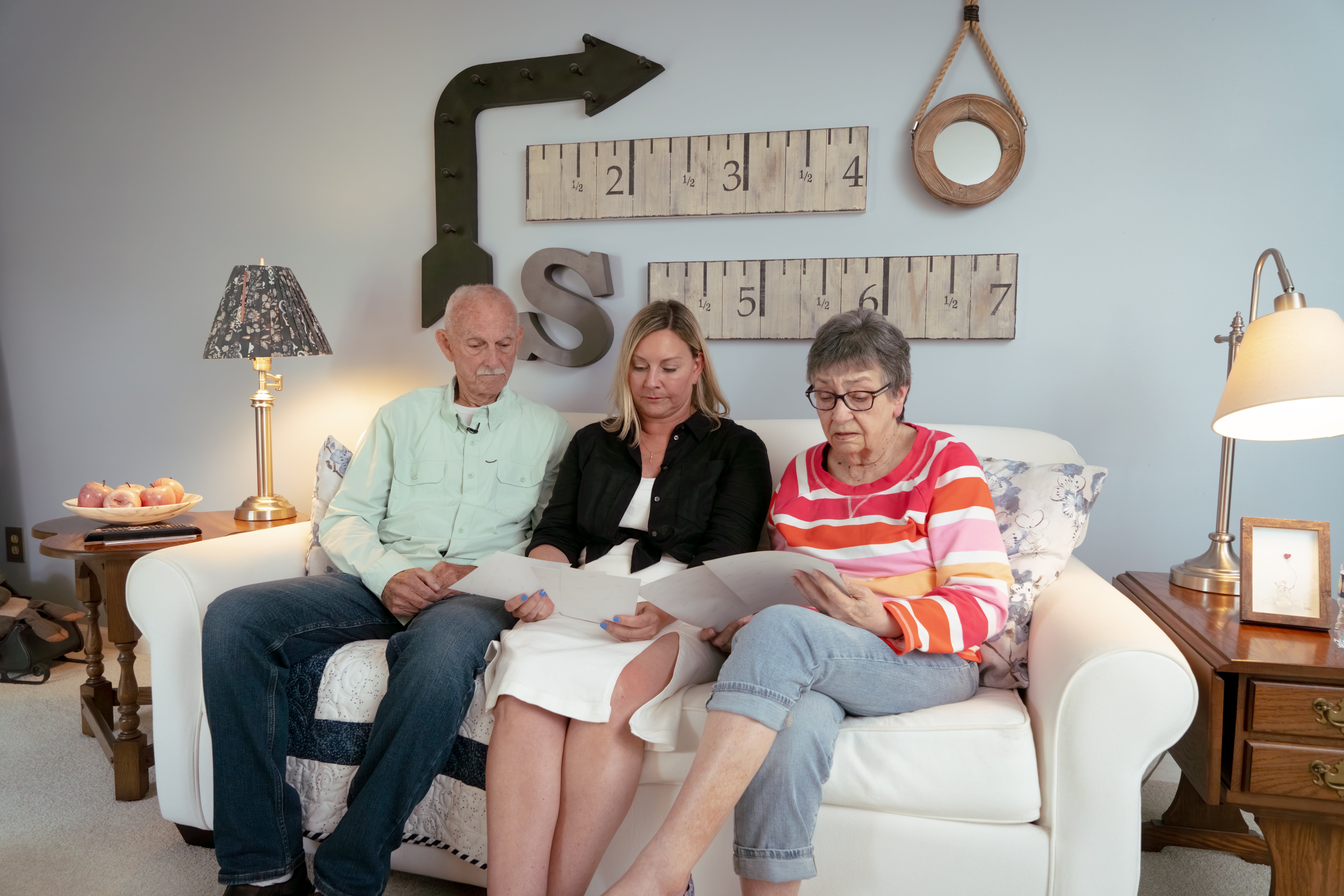 Stacey Shurr and parents on white sofa