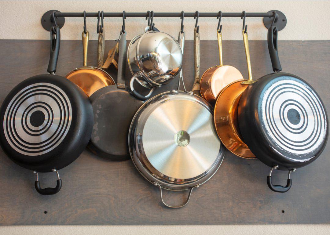 Pots and pans hanging from rack on the wall