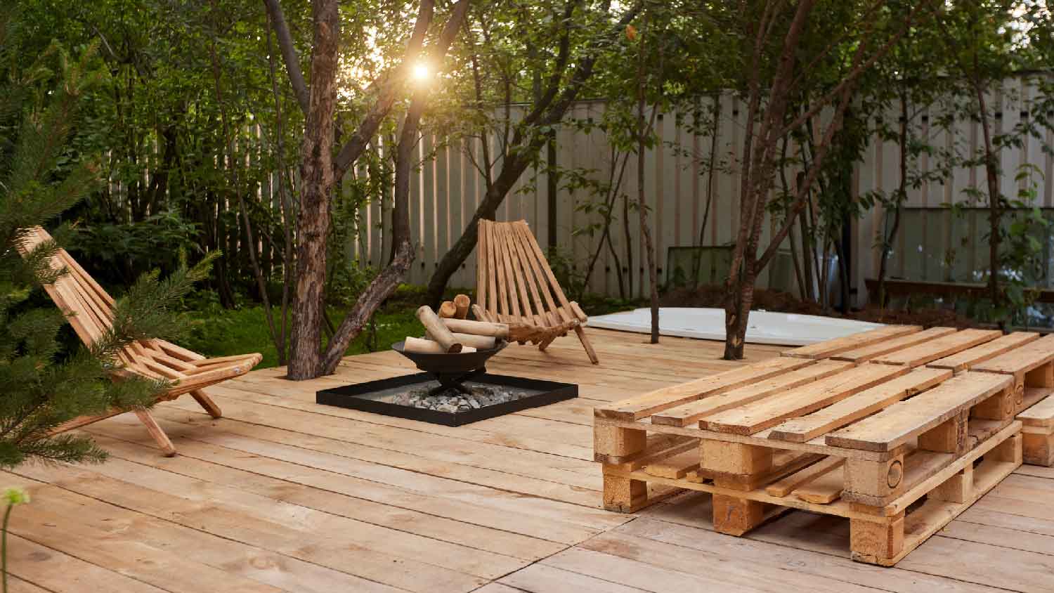 A modified wood deck with furniture and a fire pit