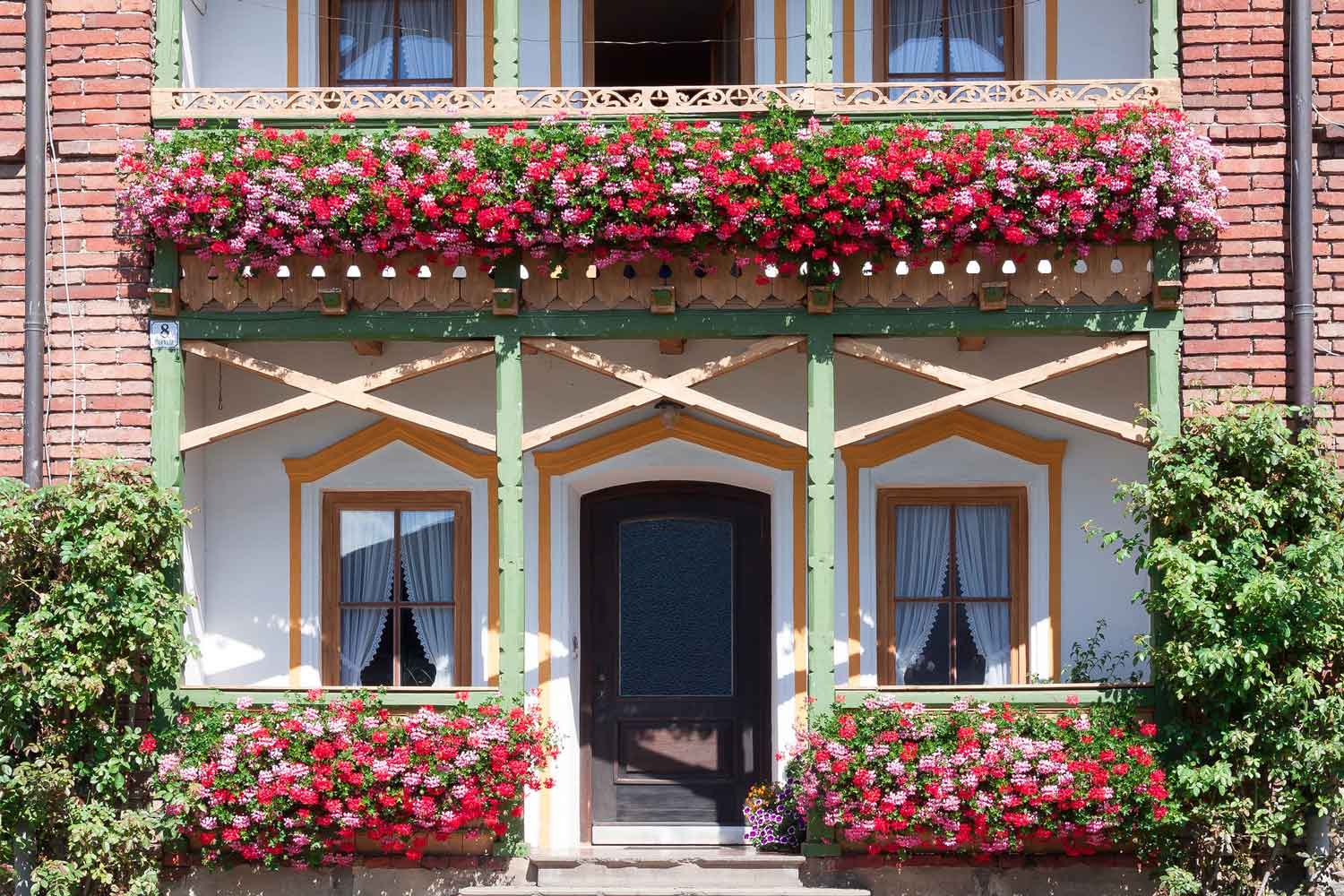 House porch with red and pink flowers