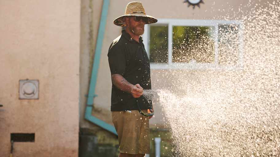 Man watering lawn.