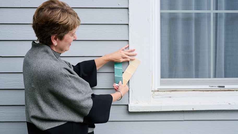 Angie Hicks picking color swatches for the window trim of this home