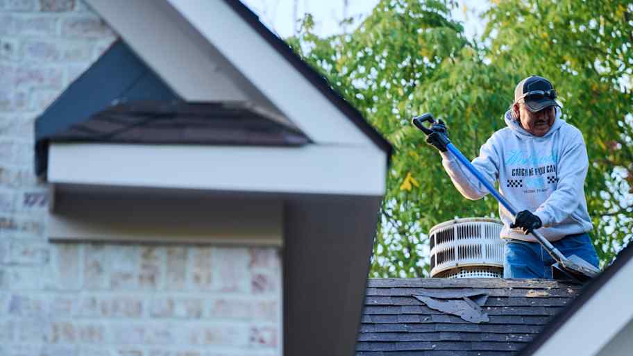 Man working on roof.