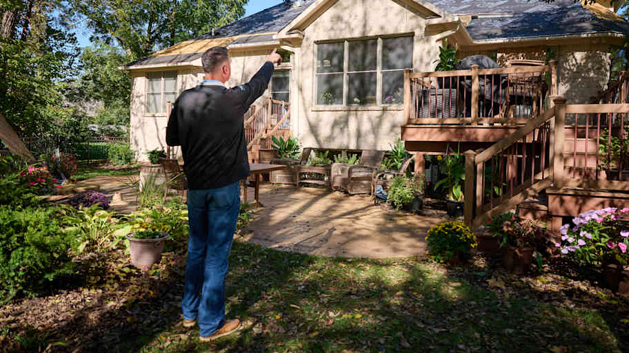 Man examining roof