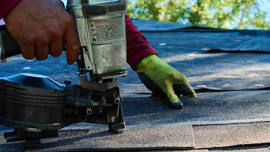 Shingles being applied to rooftop.
