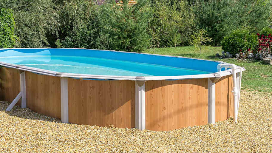 Above ground pool slightly buried in the yard