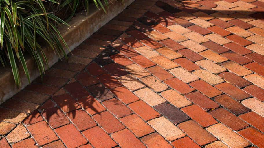 Red brick paver patio with planters