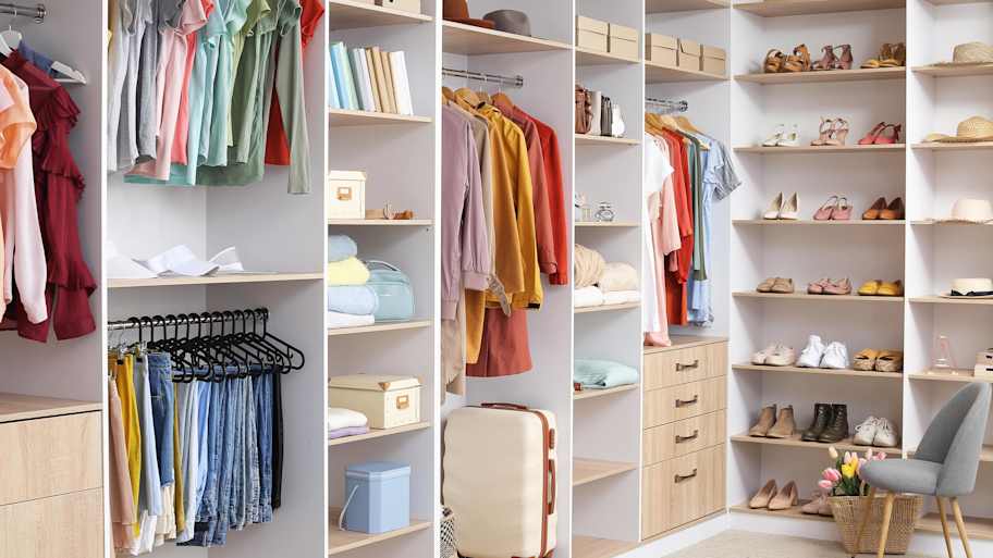 A clean and organized walk-in closet with built-in organizer