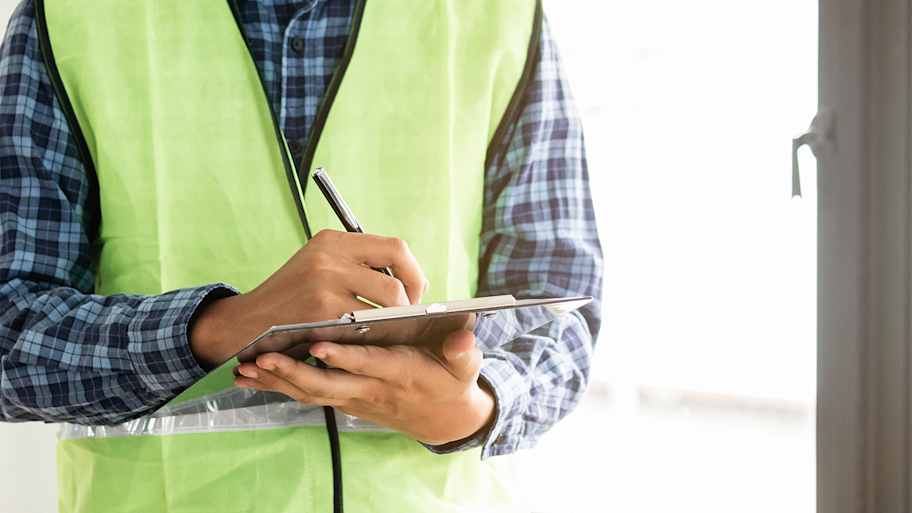 Man writing home inspection report