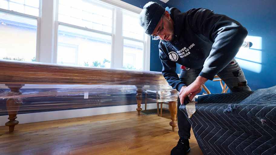Mover packing up furniture