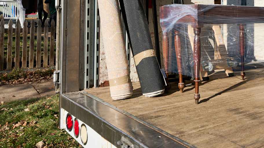 Rugs rolled up in a moving truck.