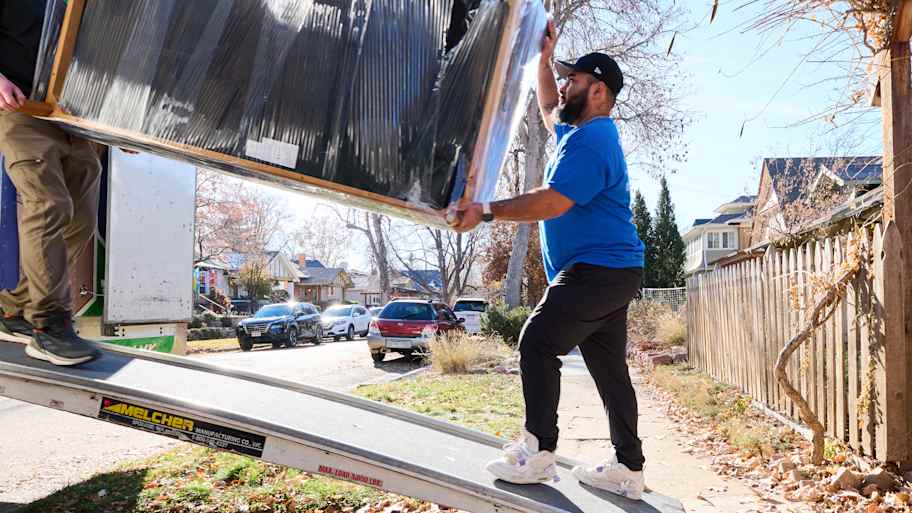 Men loading furniture into a moving truck.