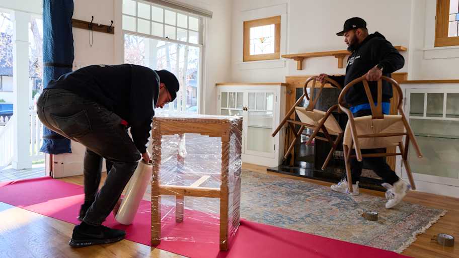 Two movers packing up house.