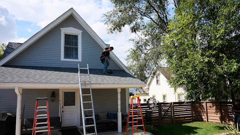 Man finishing up work on roof.