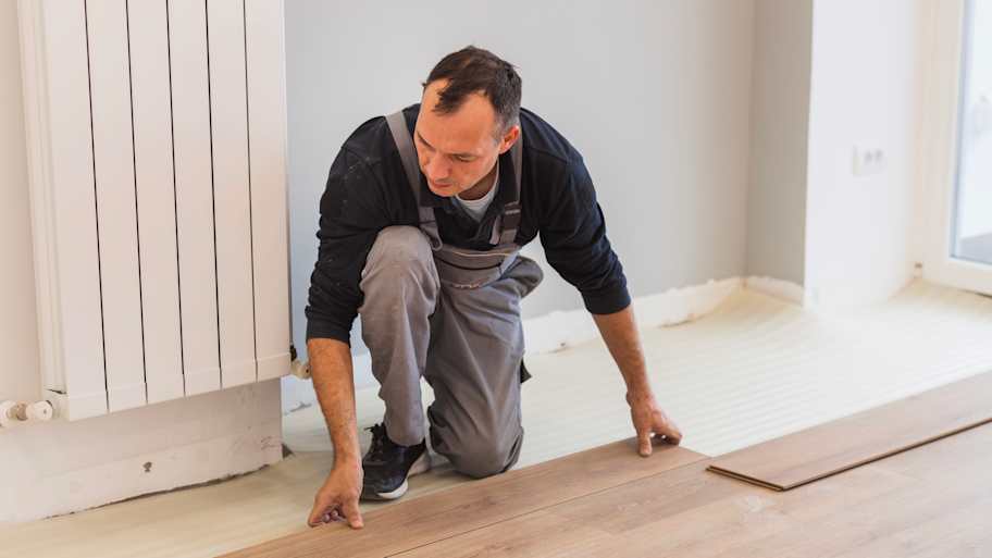 Carpenter adjusting hardwood floor