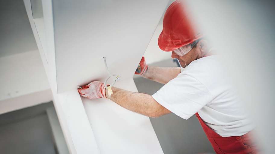 Construction worker finishing a drywall
