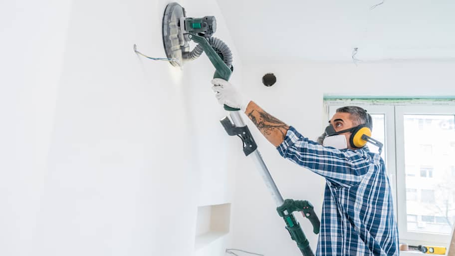 Man using vacuum sanding machine