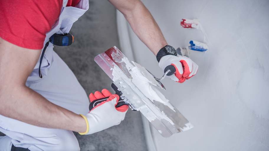 Worker with patching material and tools