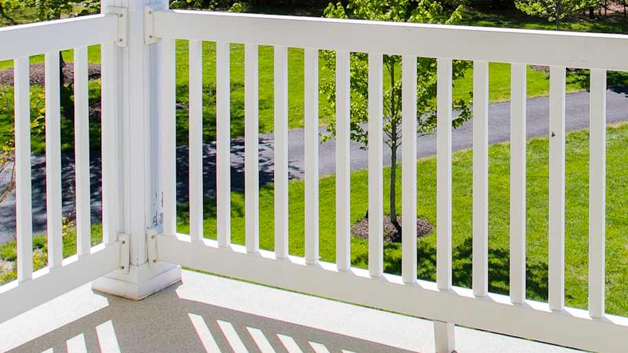 Covered deck with white vinyl railing 