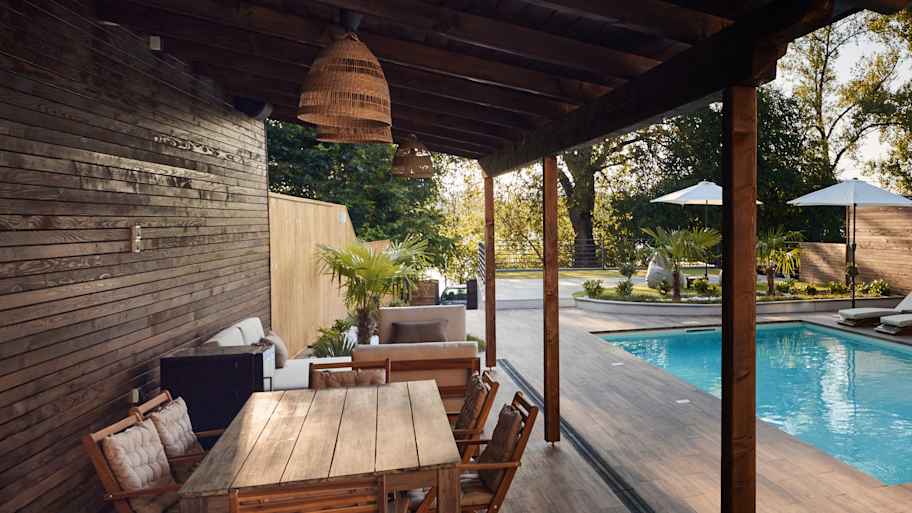 A wooden deck around a swimming pool