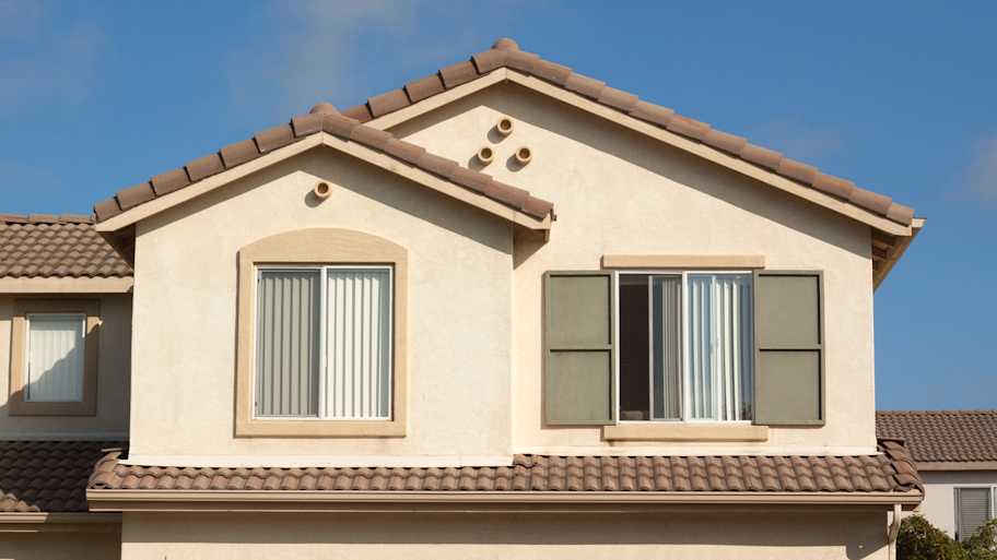 The exterior of a house with stucco walls 