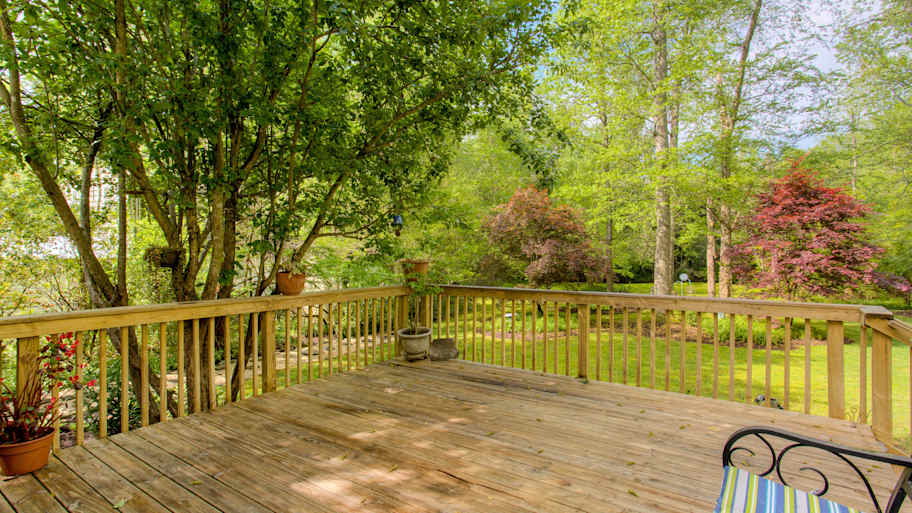 A wooden deck in the backyard during summer