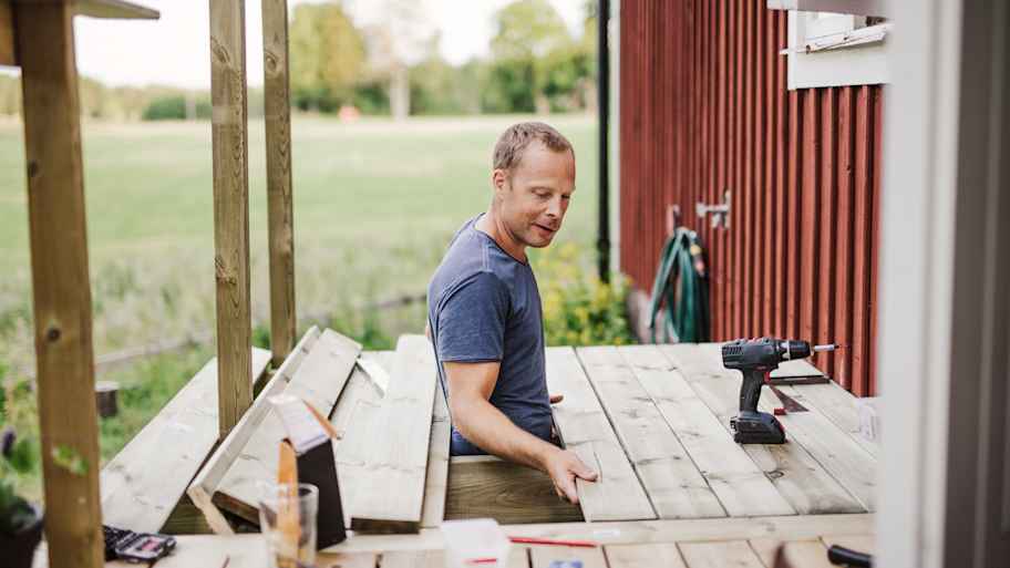 A professional replacing a wooden board on a deck