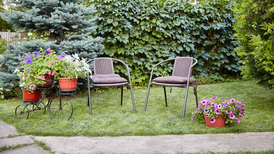 Outdoor chairs and yard decorations sitting on the lawn 