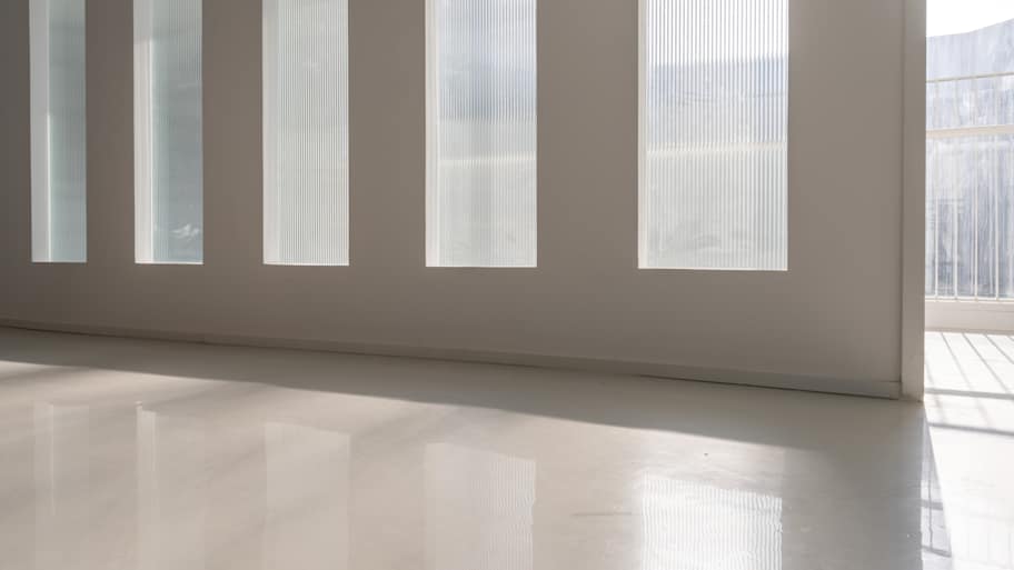 The sun shone through the room glass on the smooth ground